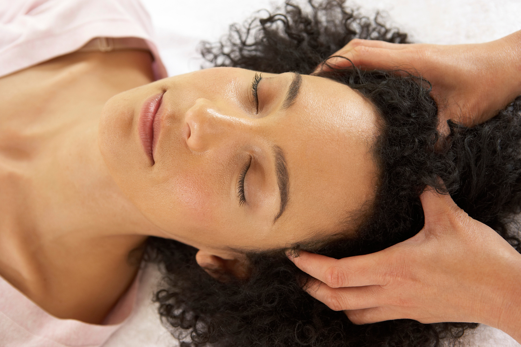 Therapist massaging woman's scalp
